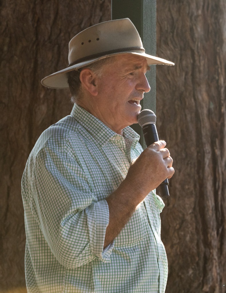 A man with a microphone calling the action