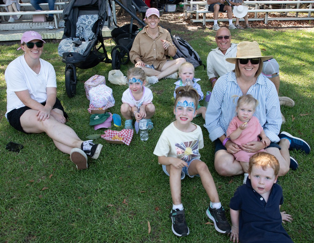 A family sitting together on the grass