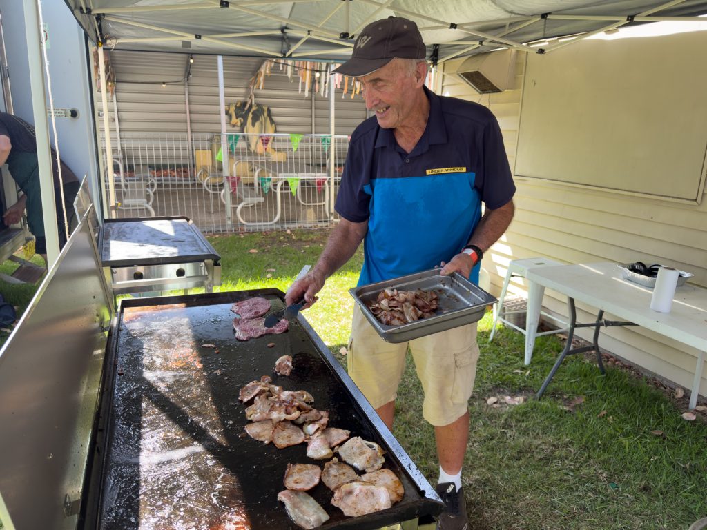 A volunteer cooking on the barbecue