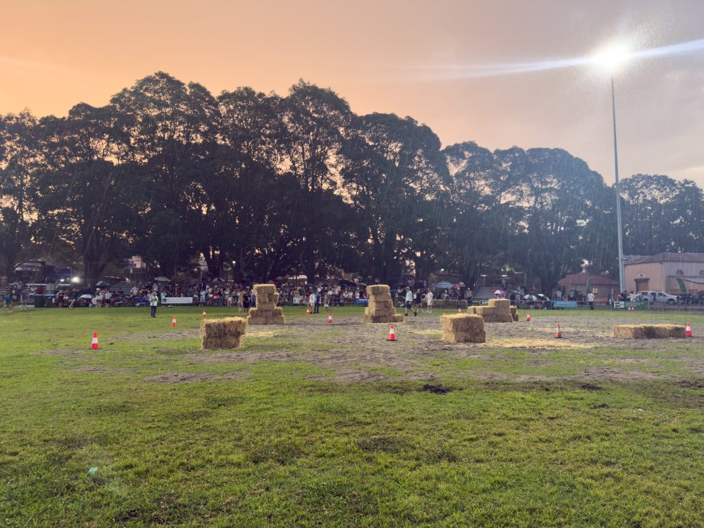 Hay bales laid out across the Main Arena at dusk