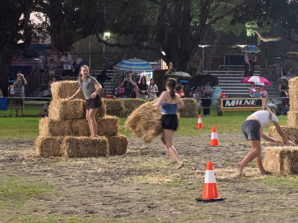 Teams racing in the hay stacking competition