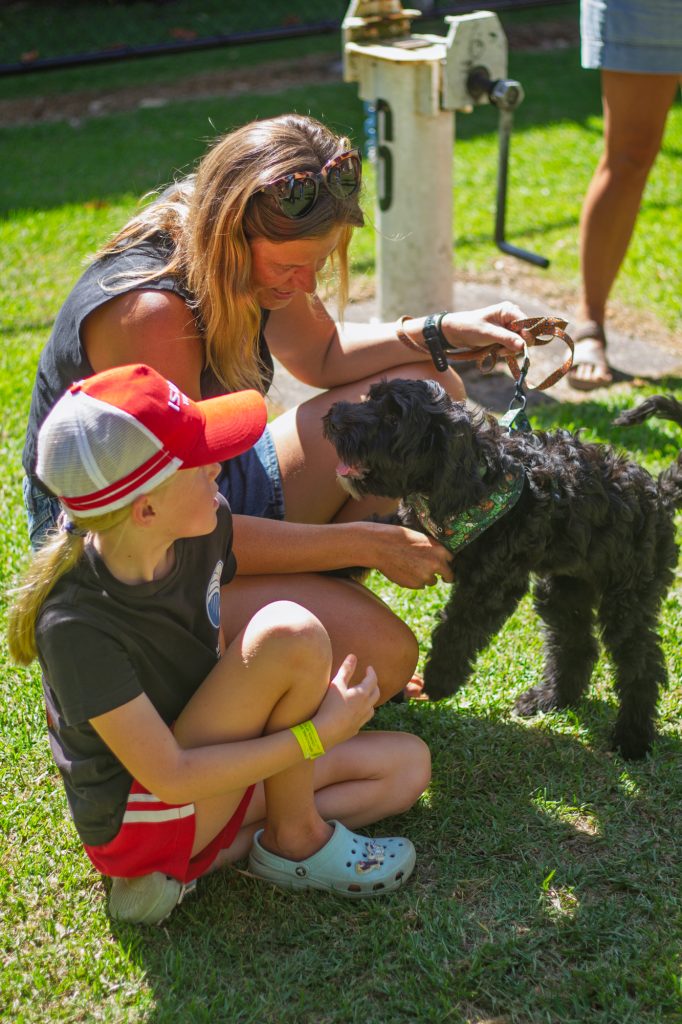 A mother and son with a black dog