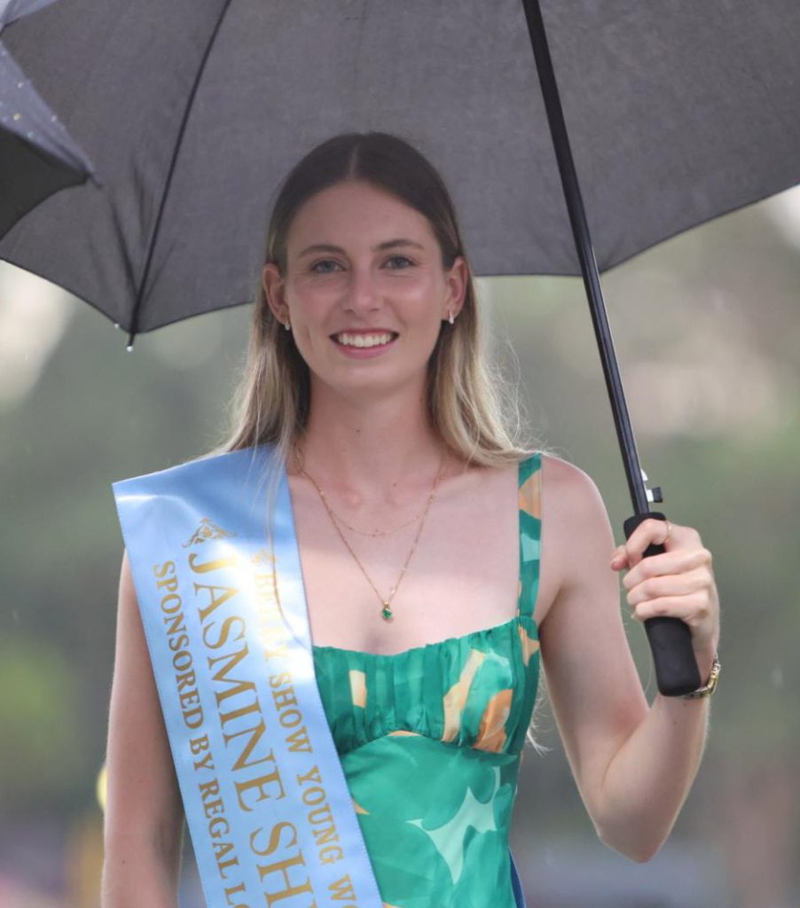Jasmine Shirlaw, the 2026 Berry Show Young Woman, under an umbrella