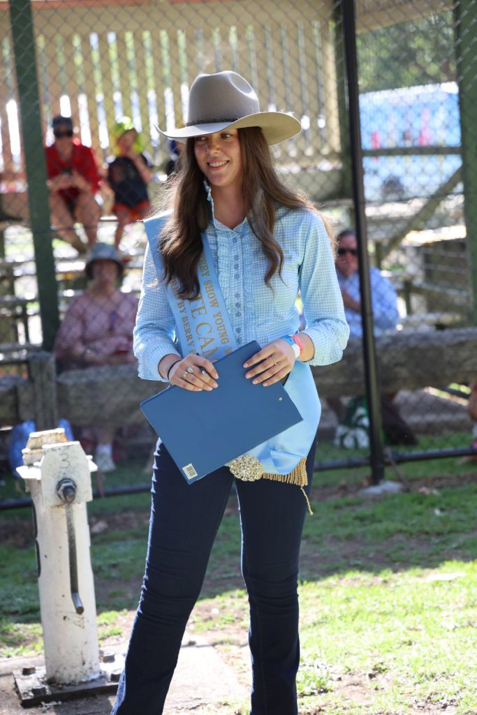 A woman in a cowboy hat holding a clipboard