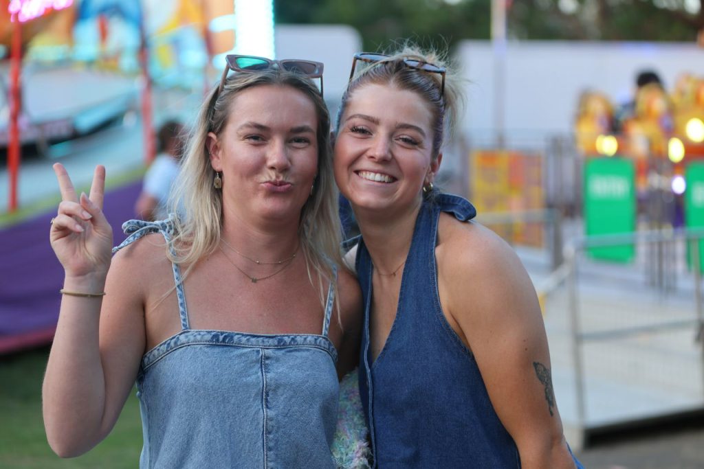 Two friends smiling in Sideshow Alley