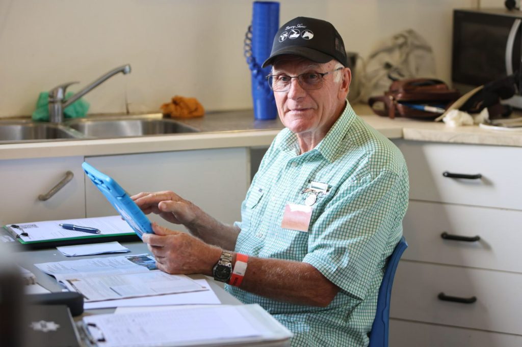A volunteer with a clipboard in the kitchen