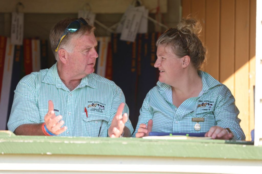 Two volunteers laughing in the steward's box
