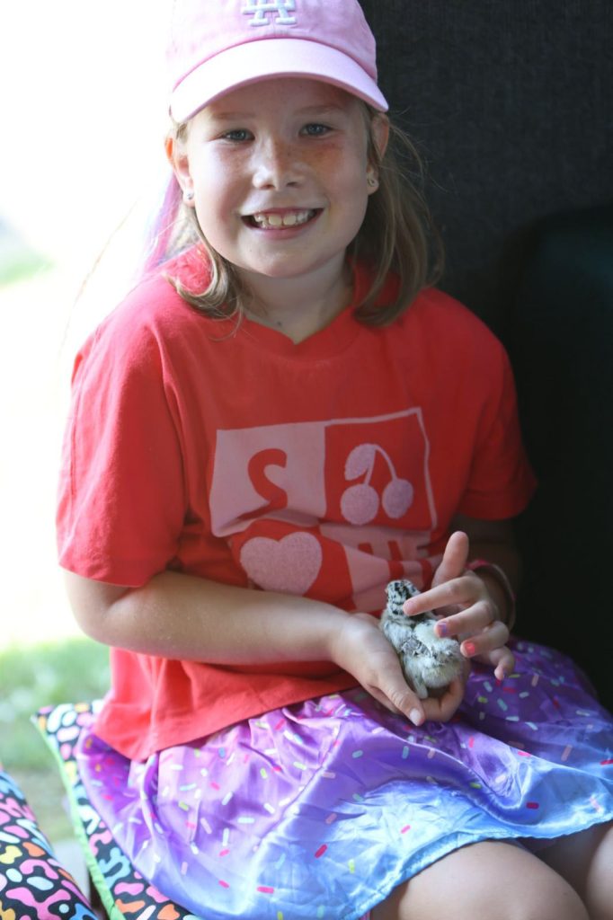 A girl in a pink cap
