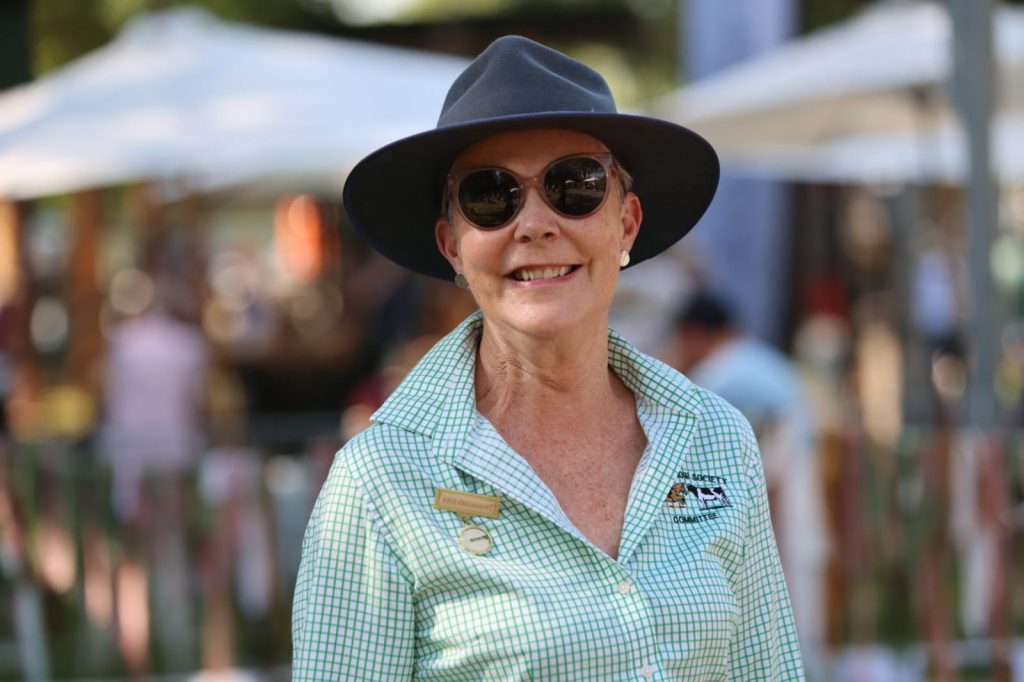 A volunteer in sunglasses and a wide-brimmed hat