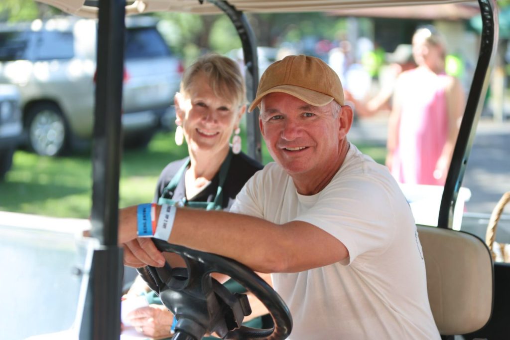 Two volunteers in a golf buggy