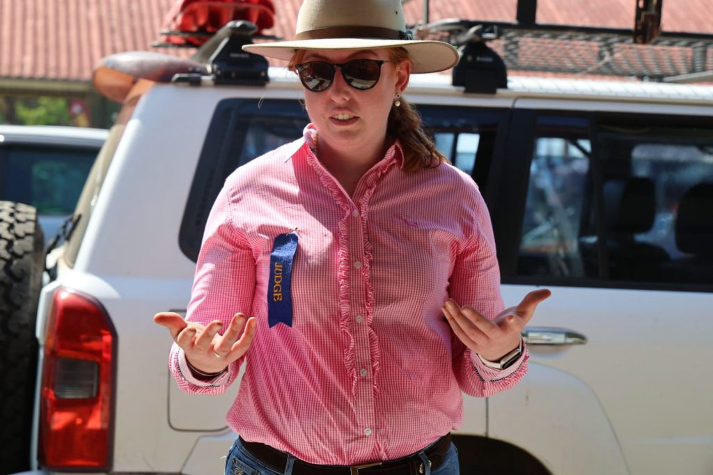 A woman with a ribbon pinned to her shirt