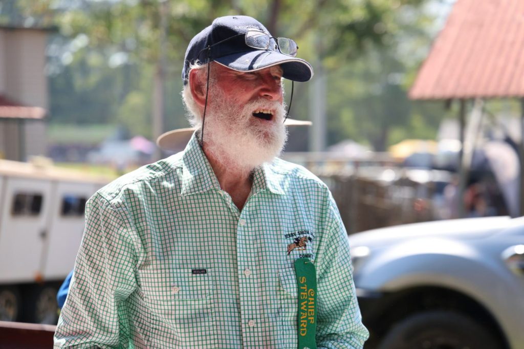 A volunteer laughing by the cattle yards