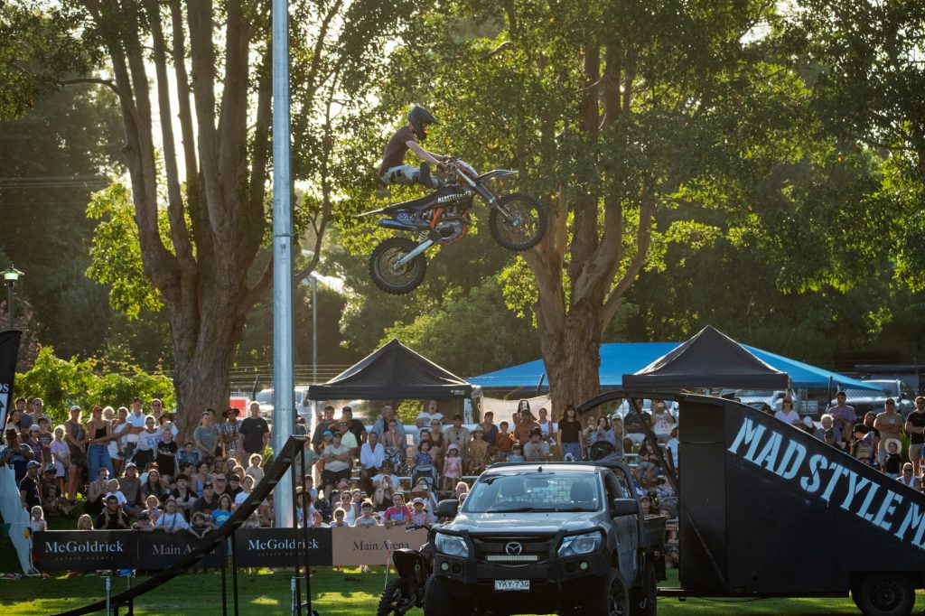 A rider flying over the trees on a motocross bike
