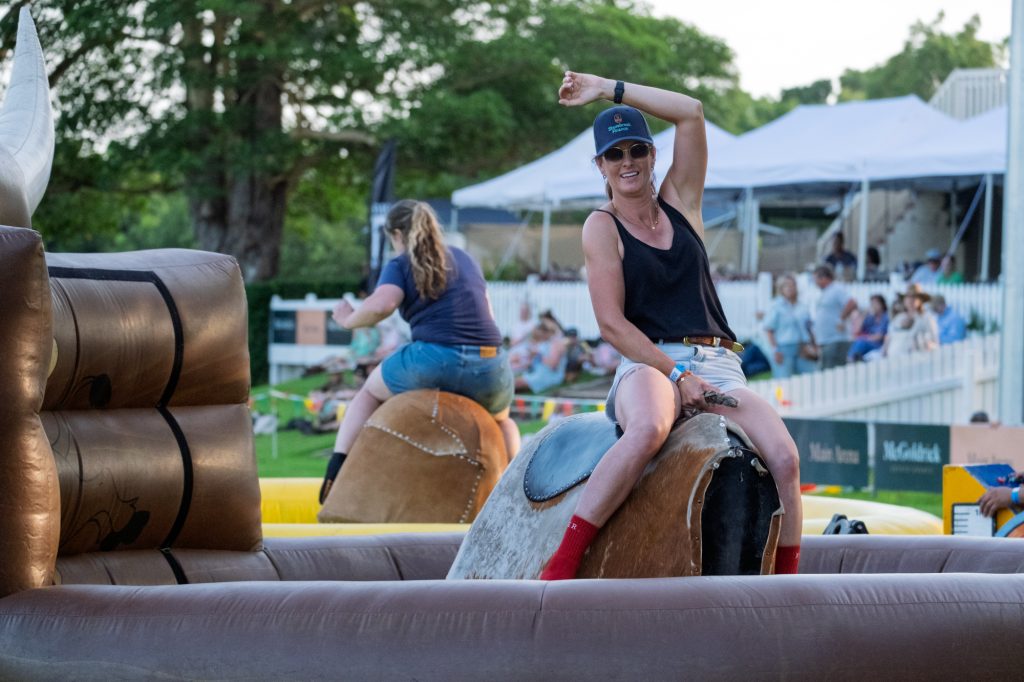 A woman riding the mechanical bull