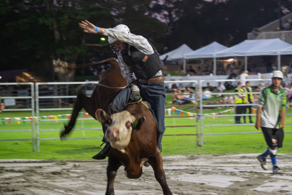 A bull rider holding on as the bull spins