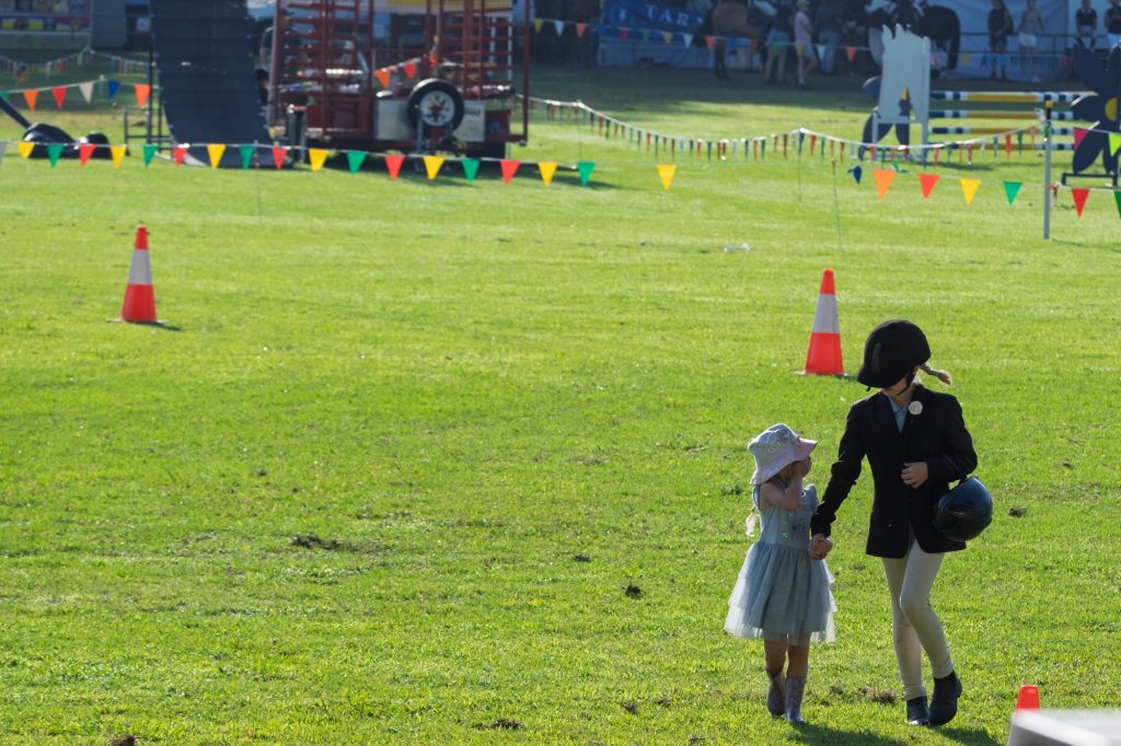 A mother and small child walking across the ring