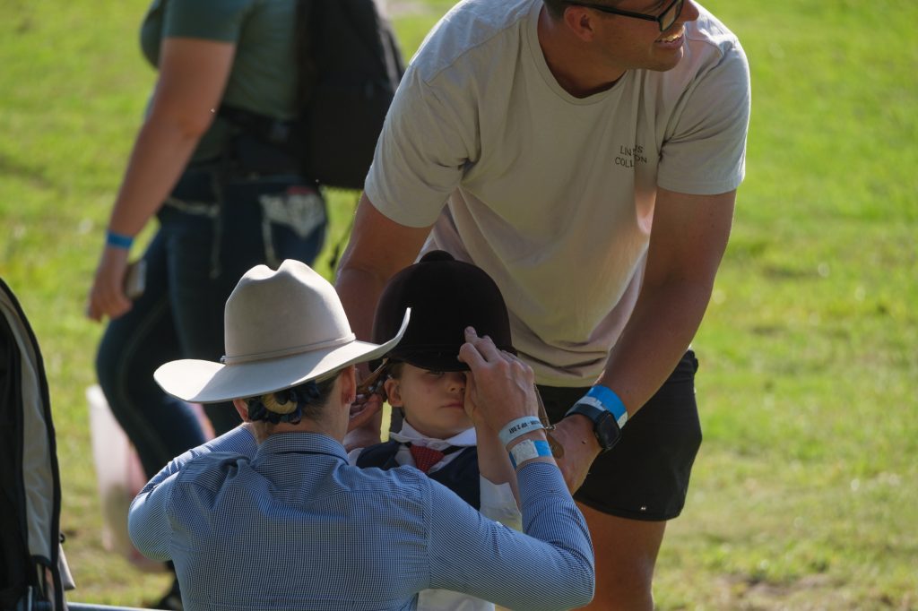 A father helping his son with his riding helmet