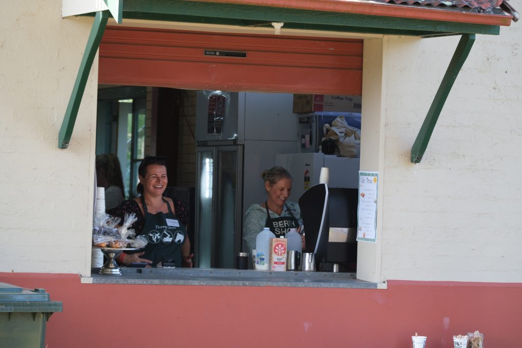 Two volunteers at the kiosk window