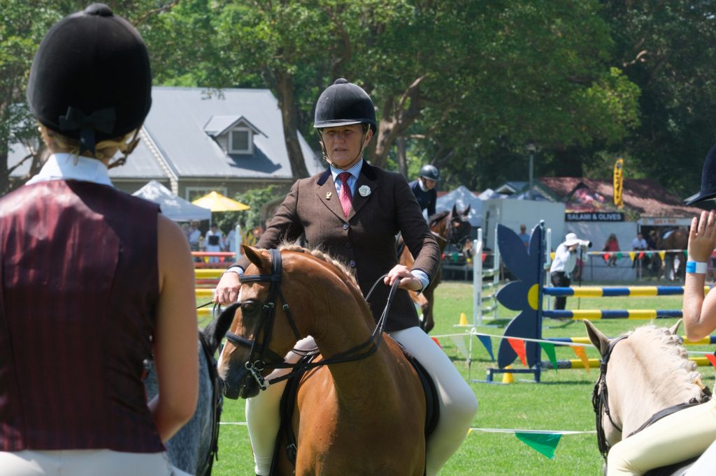Two young riders in hacking jackets on their ponies