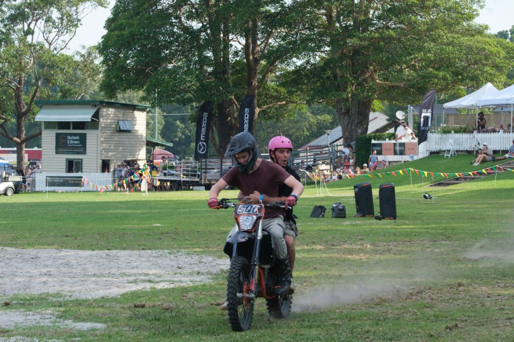 A motocross rider landing in the arena