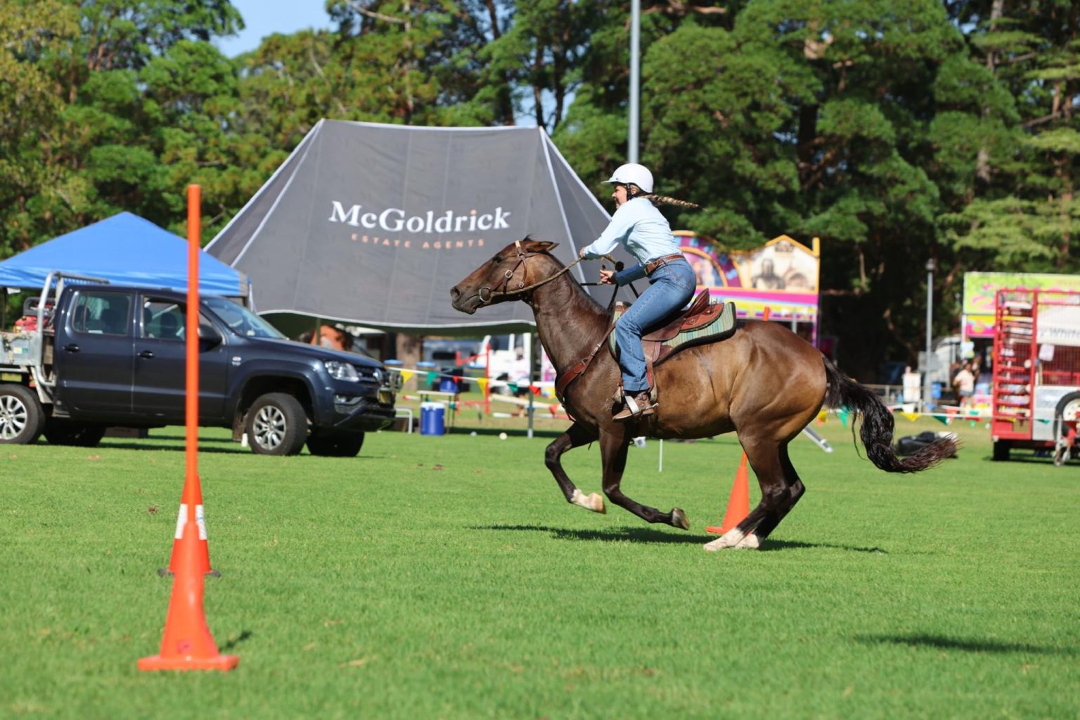 A rider cantering past the McGoldrick marquee