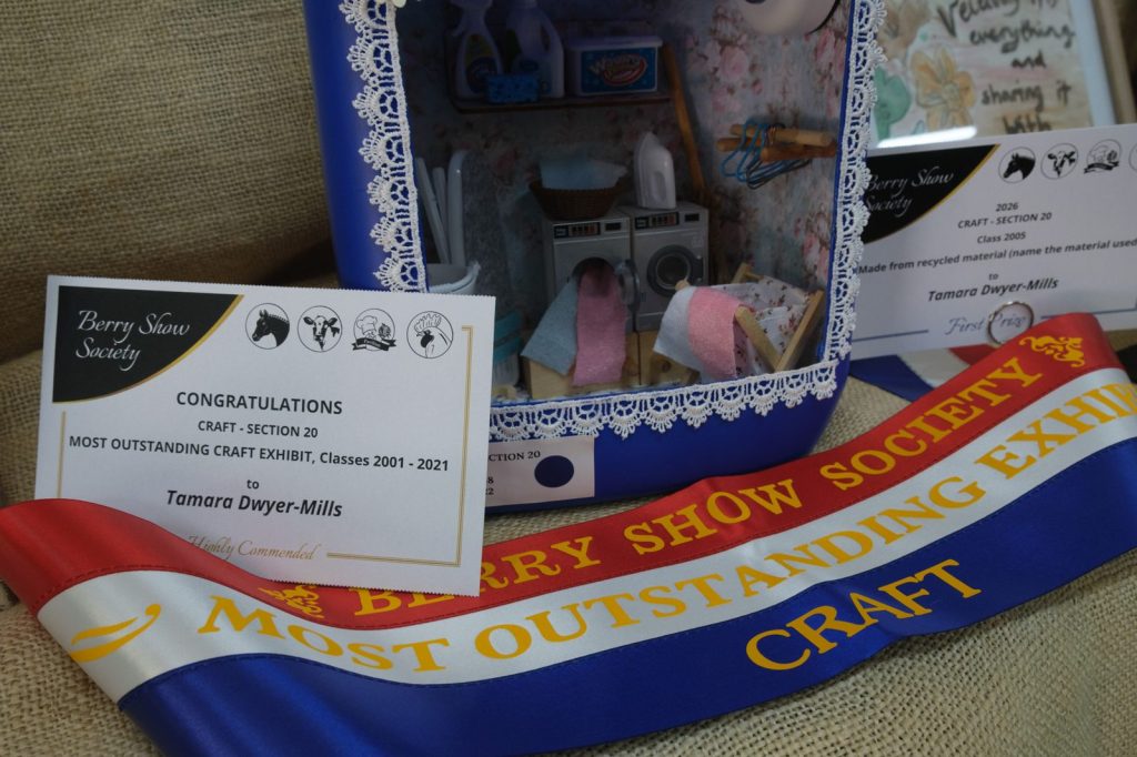 A Most Outstanding Craft Exhibit sash and certificate beside a prize-winning miniature room