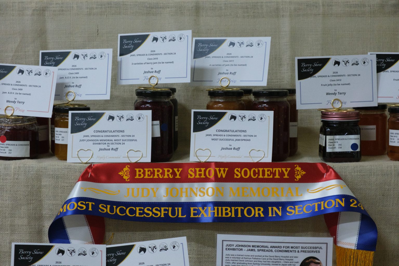 Jars of jam with prize cards and the Judy Johnson Memorial sash in the Pavilion